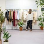 Woman Fixing Clothes on the Rack